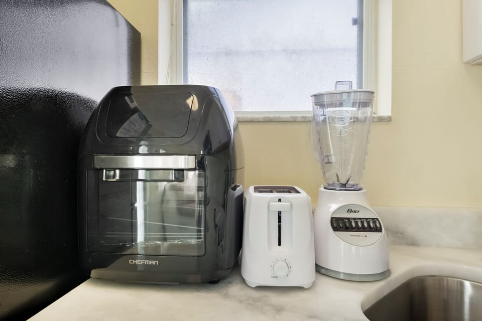 Kitchen Countertop | Air Fryer | White Two-Slice Toaster | White Blender.