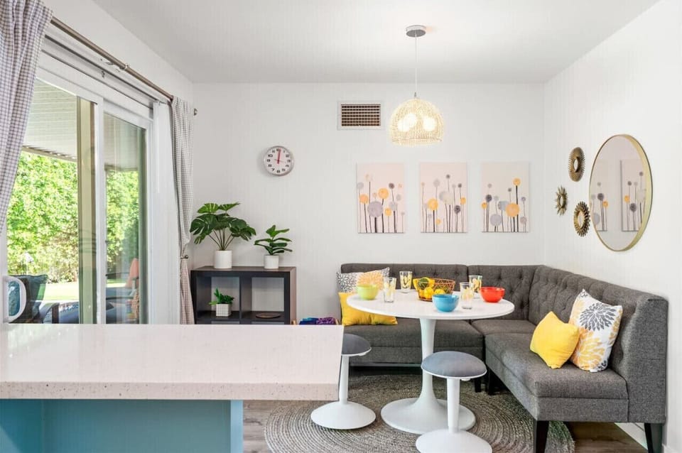 Poolside Perfection Awaits! 🌿☀️ Enjoy a bright and inviting dining nook with a seamless indoor-outdoor flow. Slide open the doors to reveal a private backyard oasis—lush greenery, a sparkling pool, and a cozy patio perfect for soaking up the Palm Springs 