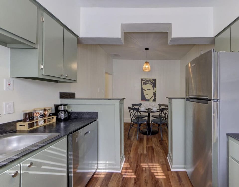 Cook and dine in style! This inviting kitchen flows seamlessly into a cozy dining area, perfect for a relaxing meal after exploring Memphis.