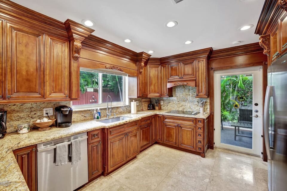 The main house features a full kitchen, equipped with modern appliances, ample counter space, and plenty of storage, perfect for all your cooking needs.