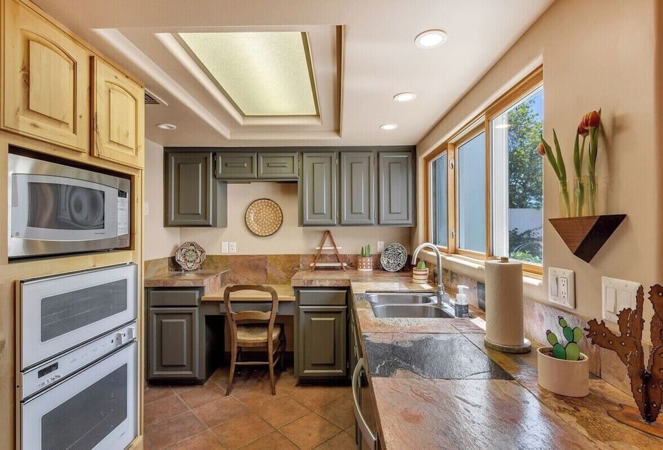 Kitchen with appliances and open view to front court yard