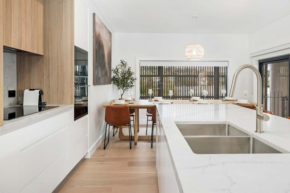 Cook with ease and style in a well-equipped kitchen featuring a sleek sink, modern oven, and efficient cooktop