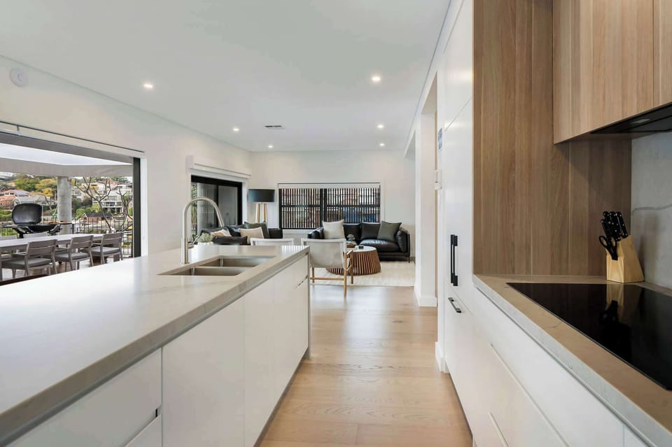 From the inviting kitchen and lounge, a hallway leads effortlessly to a balcony, creating a seamless flow between indoor comfort and outdoor relaxation