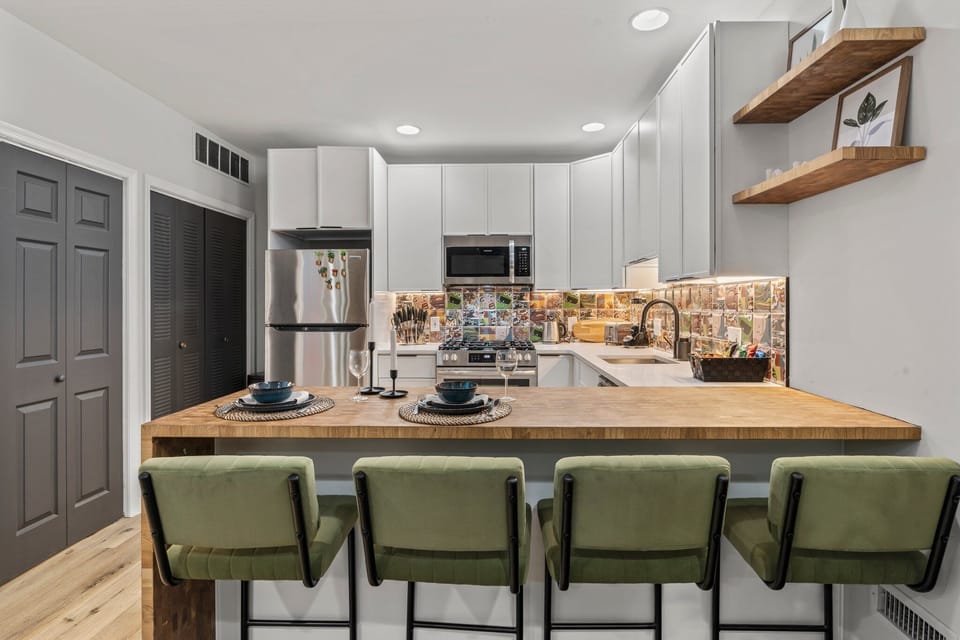 Gather around the island for breakfast or a nightcap — this sleek, fully equipped kitchen makes hosting effortless.