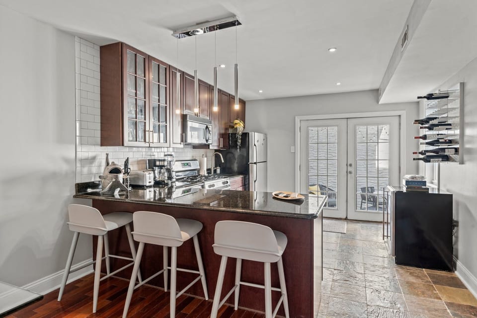 A well-equipped kitchen with stainless steel appliances and a breakfast bar is ready for your culinary adventures.