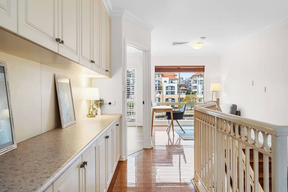 The custom built-in joinery provides both elegance and incredible utility, ensuring you have ample space for all your belongings.