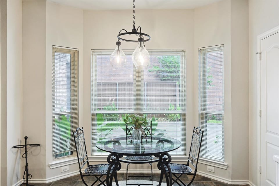 This cozy breakfast nook offers the perfect place for the first sips of your morning coffee with ornate seats and a lovely view of the yard.