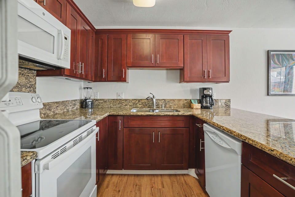 Your fully equipped kitchen features rich cherry cabinets, granite countertops, and all the appliances you need to whip up a delicious meal during your stay.