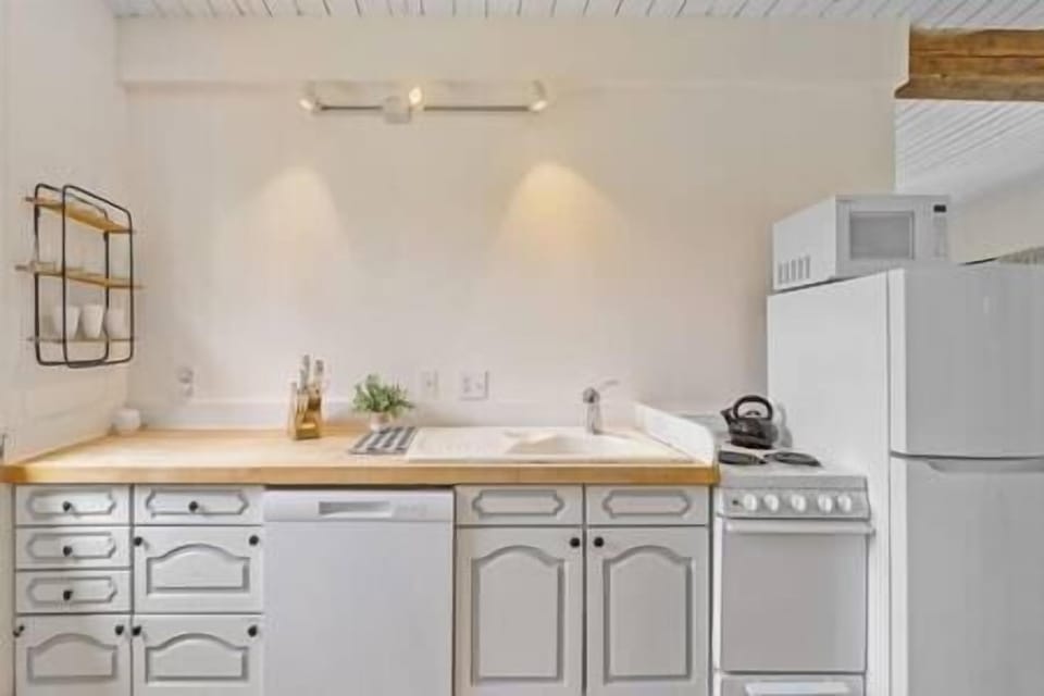 Light and Bright full kitchen in attached apartment is small but has all the amenities. 