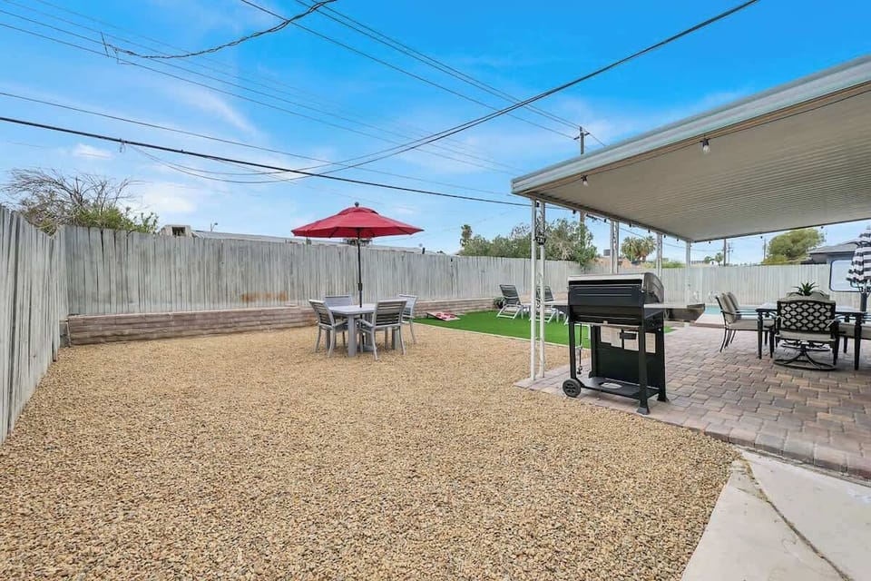 Chill by the pool, BBQ, and enjoy some cornhole in this inviting backyard!