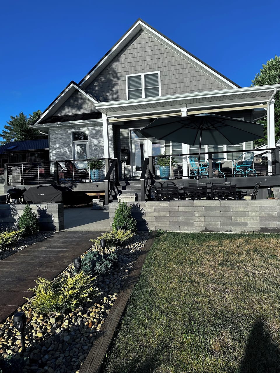 Lake side view of house with spa in deck