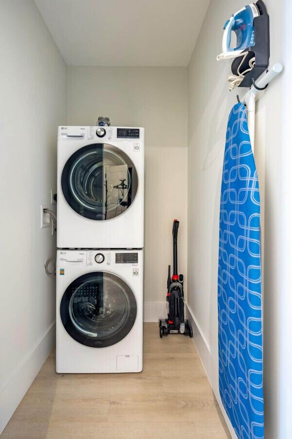 Laundry room with Washer, Dryer, Iron, Ironing Board and Vacuum
