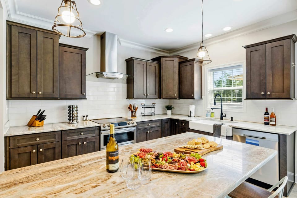 Stylish kitchen with a spacious marble island, perfect for entertaining with a charcuterie board and wine
