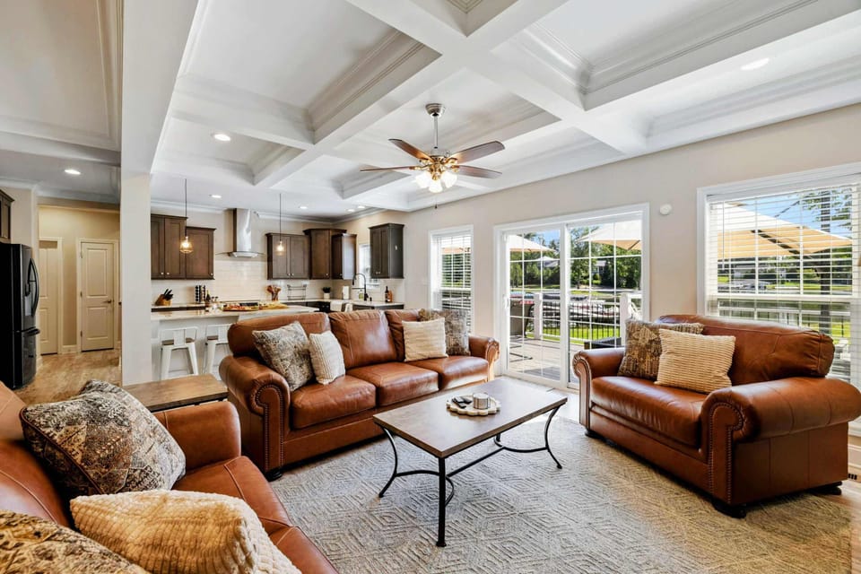 Spacious and beautifully decorated living room with comfortable seating and plenty of natural light