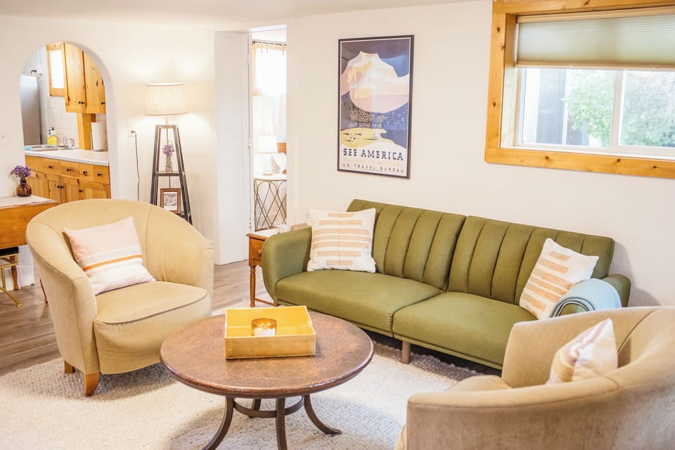 Bright and open living room with a couch that turns into a fold-out bed. 