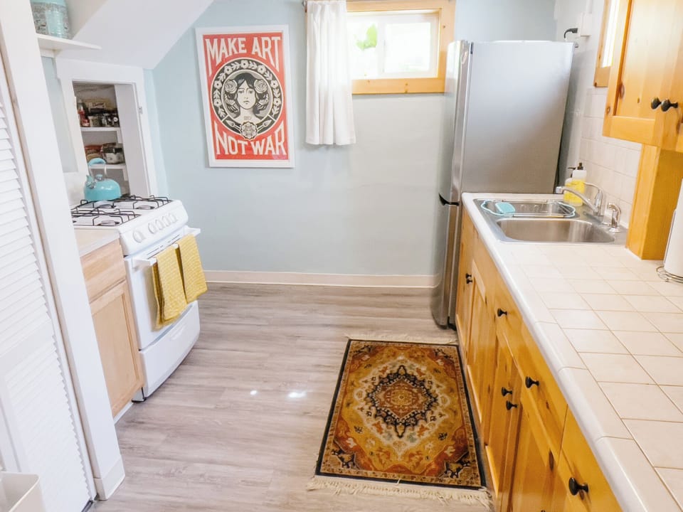 Full kitchen equipped with an oven, fridge, microwave and stocked pantry. 