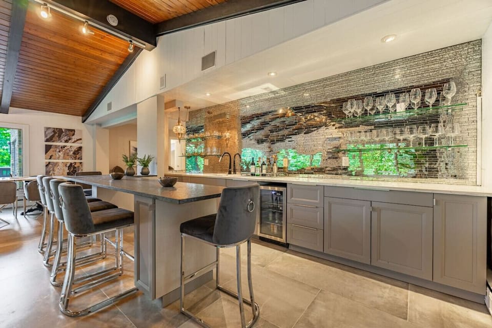 Glamorous bar with seating for six complete with Quartz counters and mini fridge