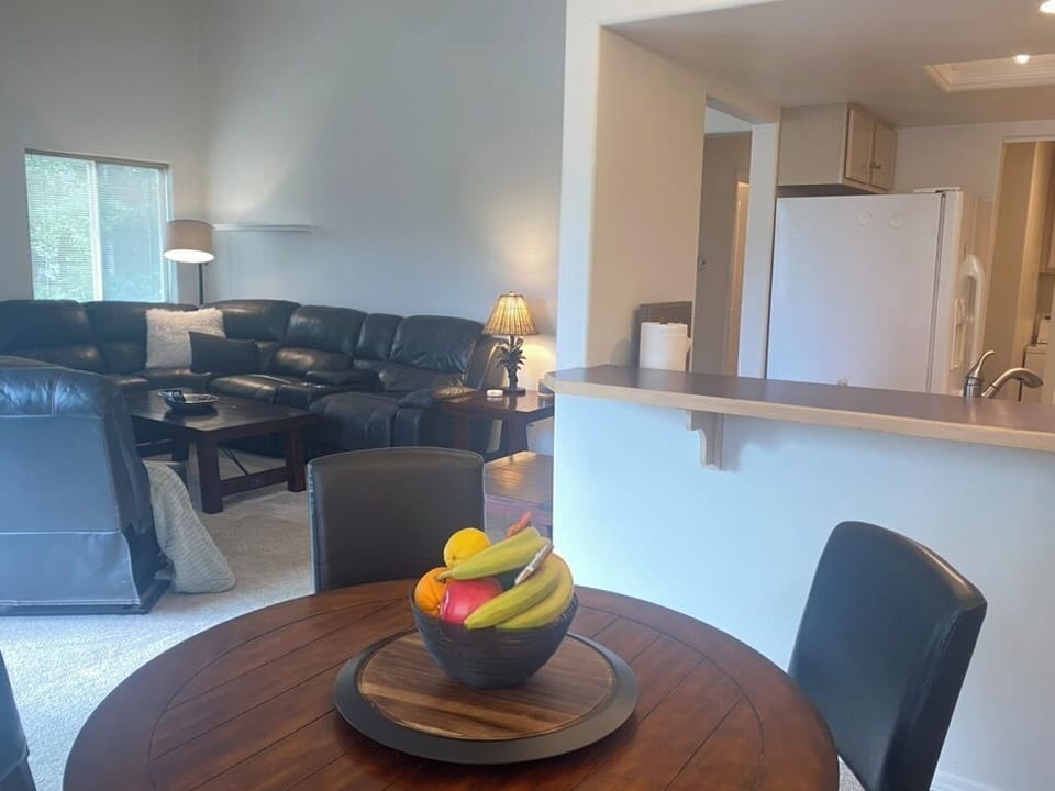 Dining and living area with open kitchen and counter/bar.