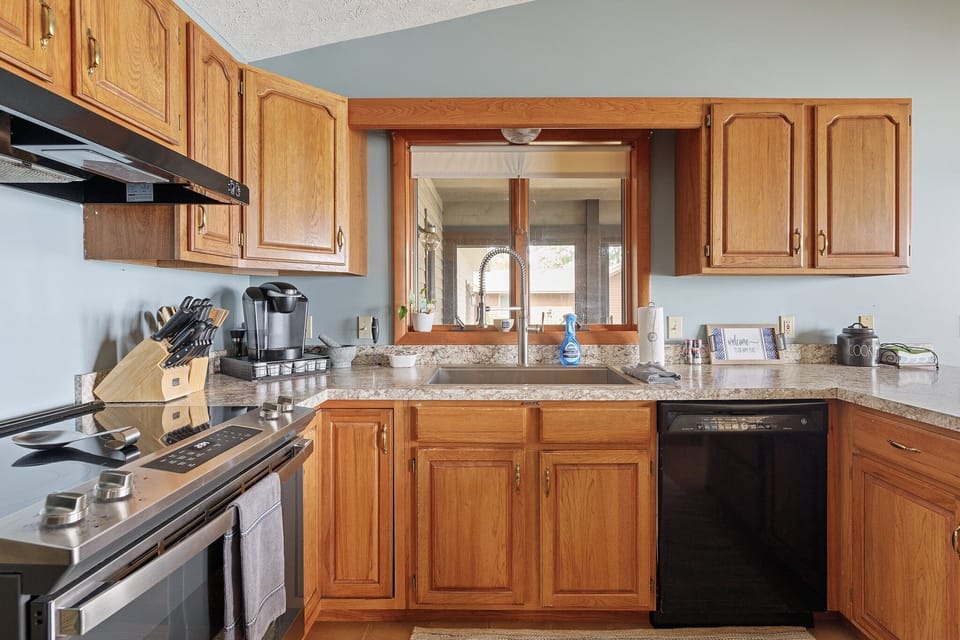Well-equipped kitchen w/ generous counter space, dishwasher & window over the sink.