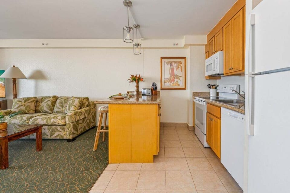 Fully equipped kitchen with granite countertop and white appliances