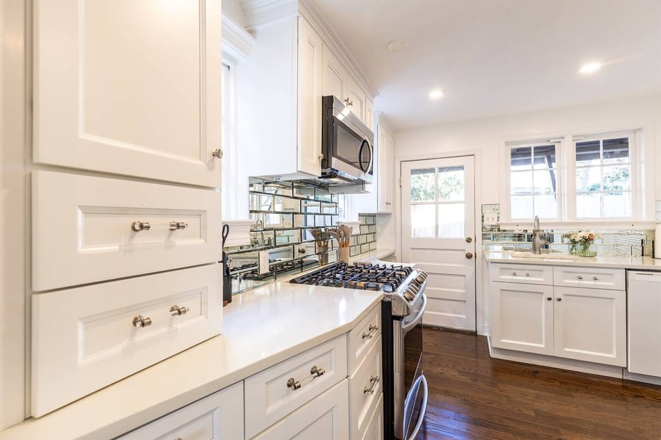 The gourmet kitchen has been recently renovated with custom cabinets, countertops and stainless steel appliances.