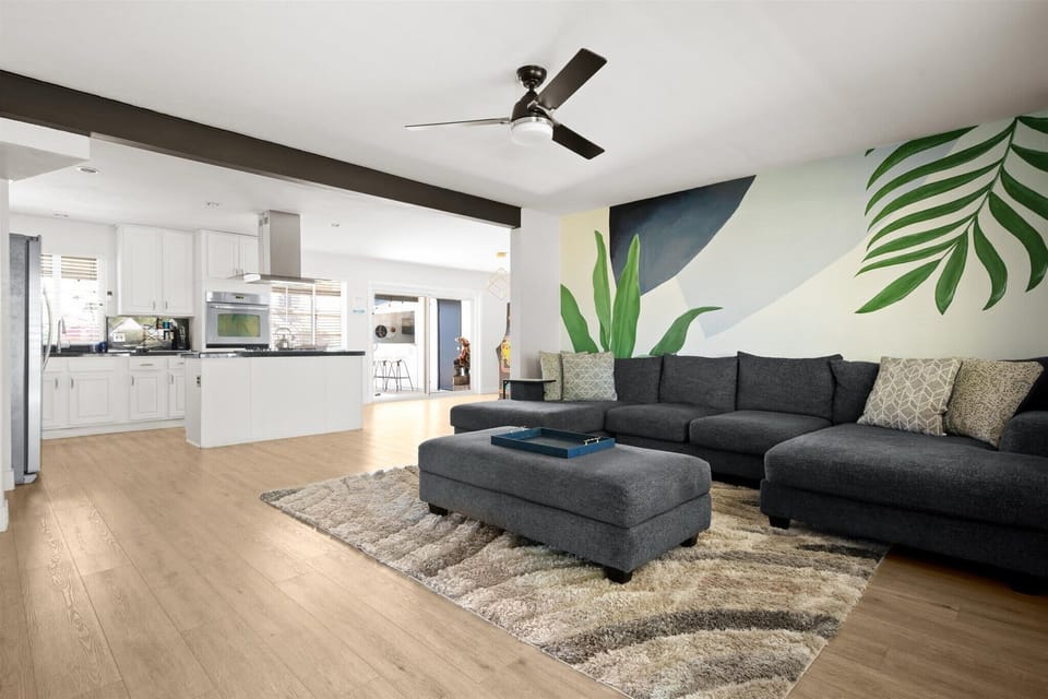 Step into our bright and open living room, perfectly adjacent to the heart of the home – the kitchen