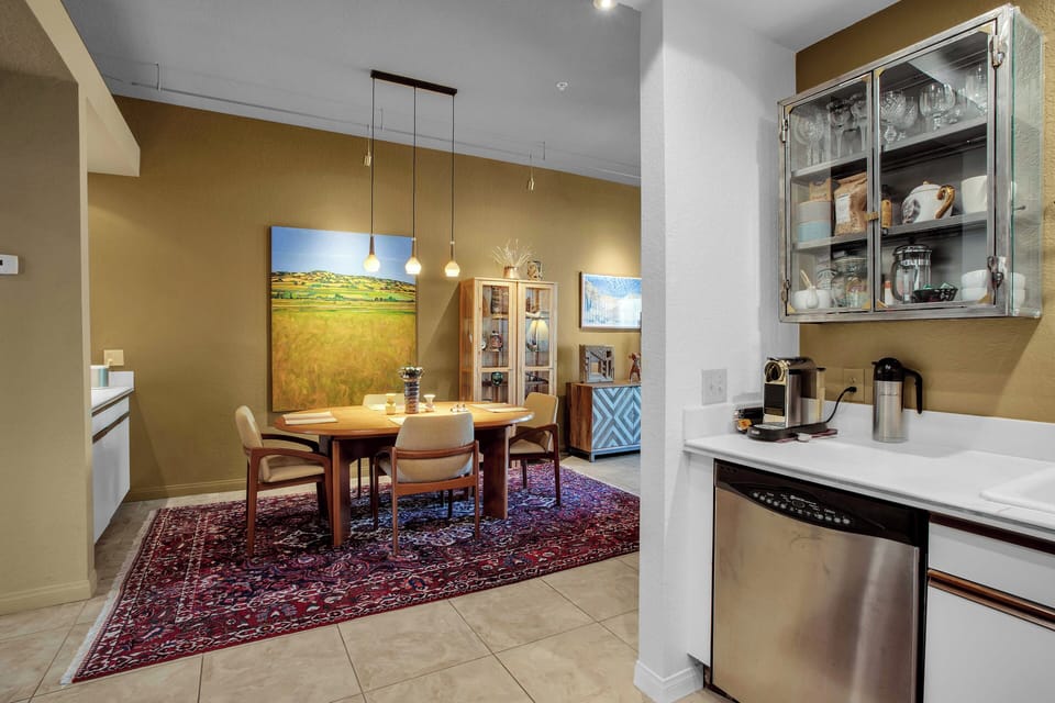 Dining room with designer lighting and desert-inspired artwork