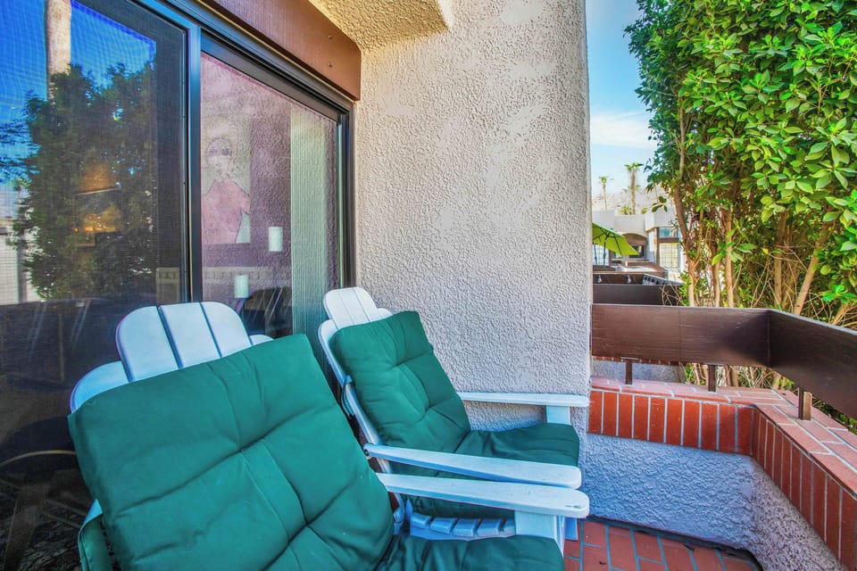 Private patio with lounge chairs and garden views