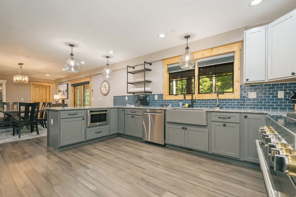 The kitchen has a microwave, dishwasher, and gas stove/oven.