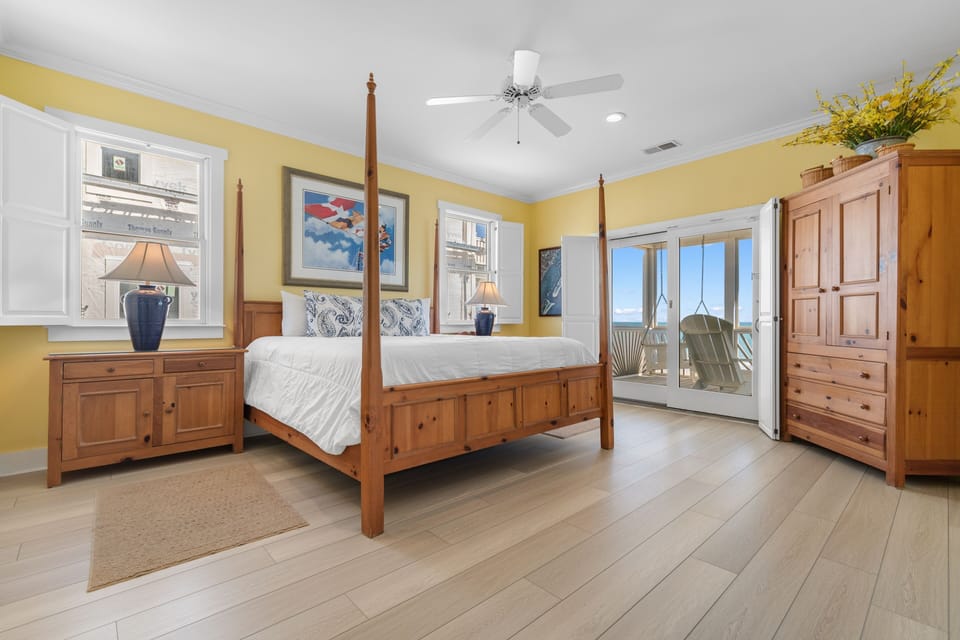 Your spacious bedroom features elegant four-poster bed and opens to private balcony with stunning ocean views.