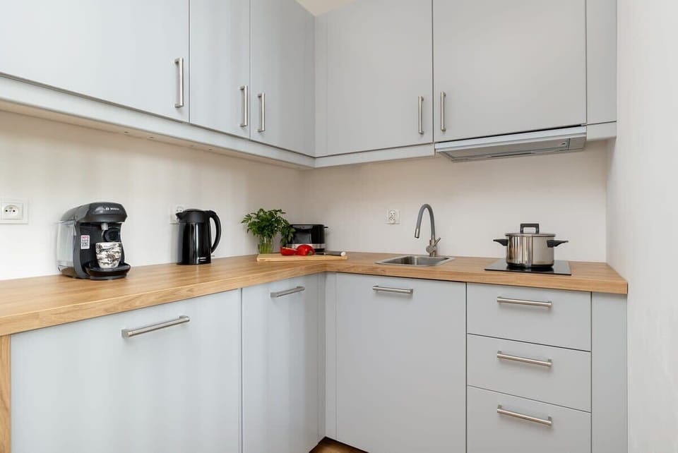 Modern kitchenette with kettle, coffee maker, and everything you need for cooking.