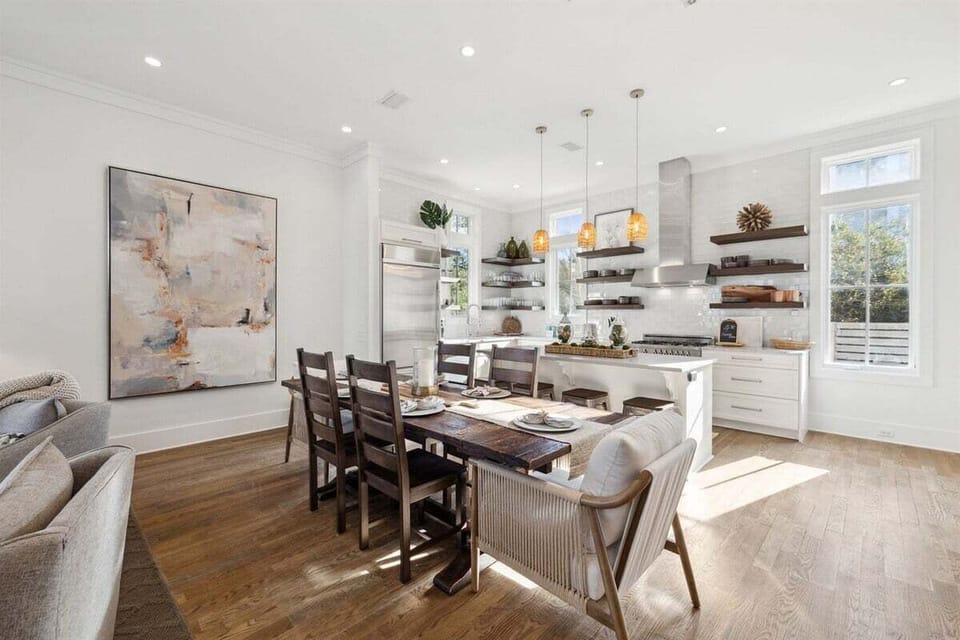 Kitchen area with dining table that seats six, with extra seating at the kitchen island