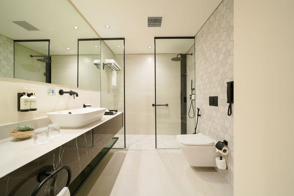 Premium Suite, 1 Bedroom (Spacious) | Bathroom | Shower, rainfall showerhead, hair dryer, bathrobes