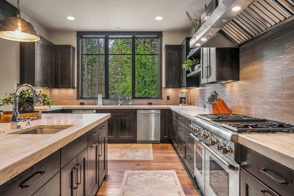 Refresh in your beautifully designed bathroom featuring rustic wood accents, a sleek modern sink, and thoughtful decor that blends mountain charm with contemporary style.