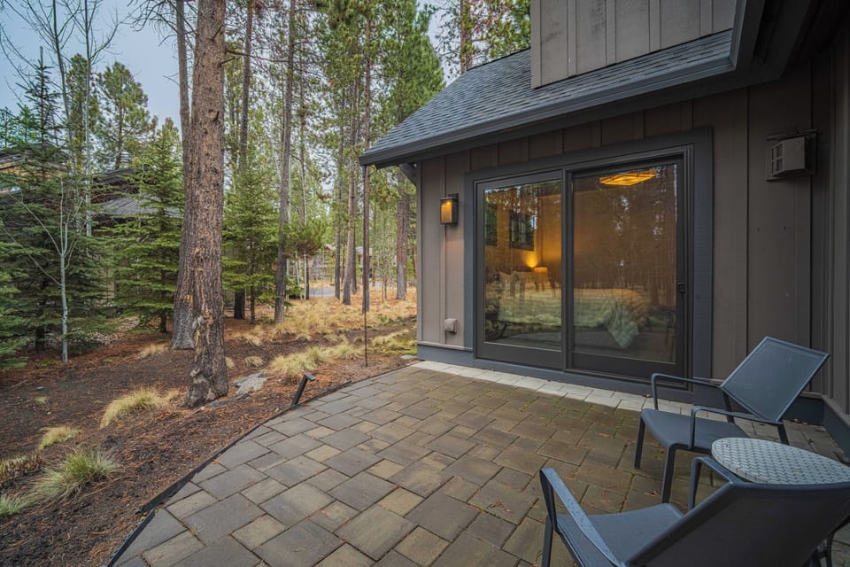 Step onto your private patio and breathe in the fresh mountain air while enjoying morning coffee surrounded by towering pines and peaceful forest views.