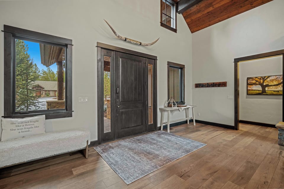 Step into your mountain retreat where rustic charm meets modern comfort beneath soaring wooden beams and natural light.