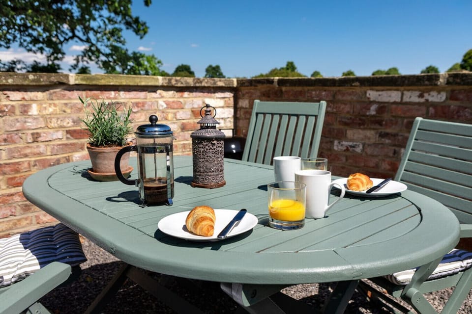 Enjoy a peaceful breakfast on the outdoor terrace at Moat Cottage, surrounded by nature and the beauty of North Yorkshire.