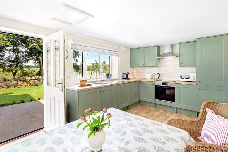 Open the doors from the kitchen to the terrace and enjoy al fresco dining with stunning views – a perfect way to savour your Yorkshire retreat.