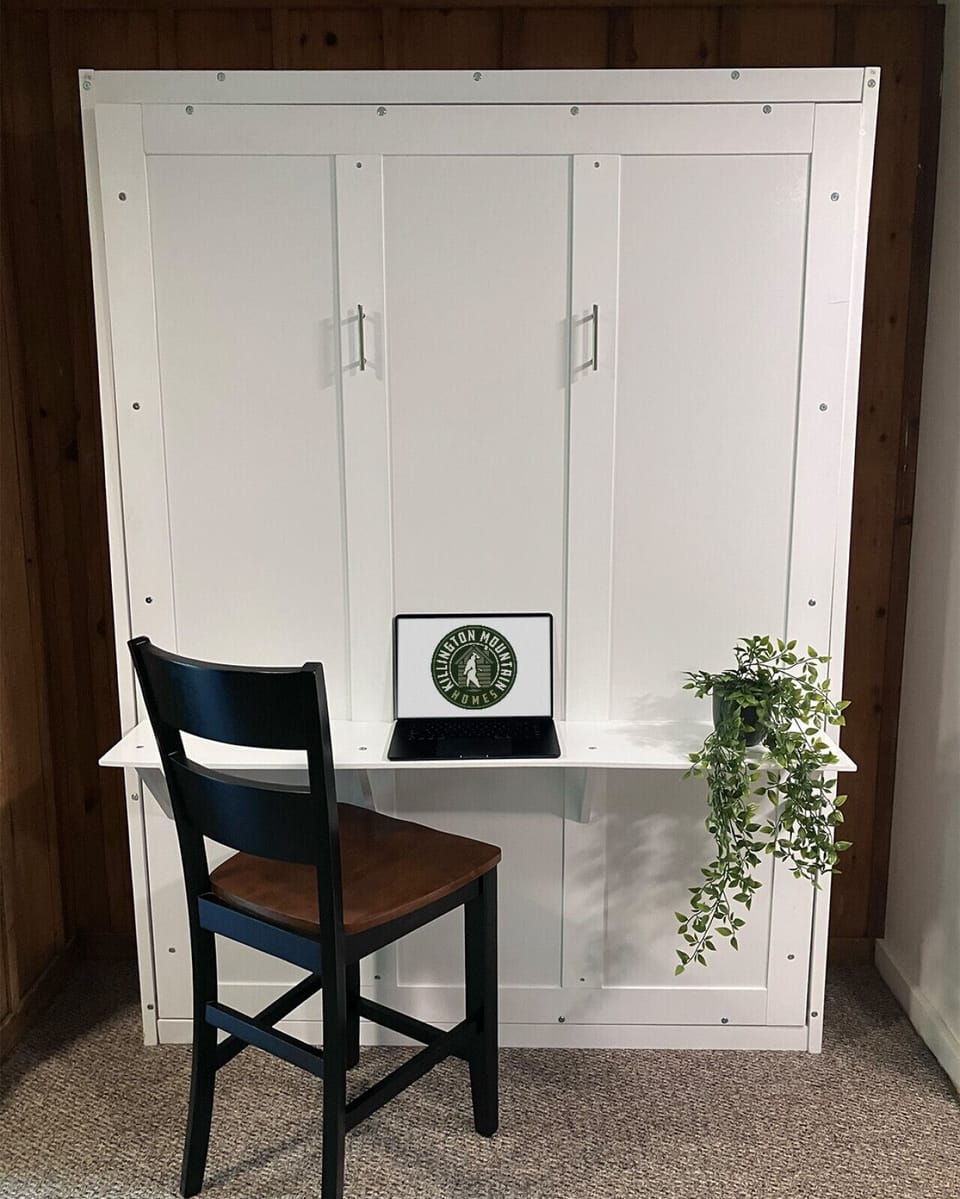 Functional workspace in the living room that folds out into a Murphy bed.
