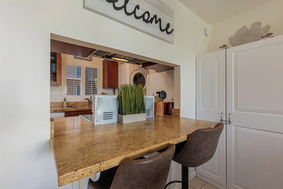 Enjoy morning coffee at your granite breakfast bar while natural light streams through the kitchen window.