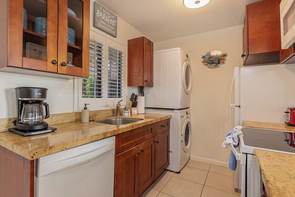 Your well-appointed kitchen features granite counters, modern appliances, and convenient in-unit laundry facilities for effortless meal prep and easy upkeep.