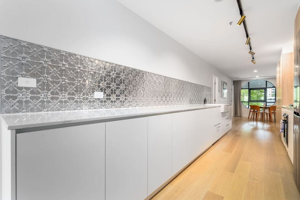 Spacious modern kitchen with sleek appliances, ample counter space, and contemporary finishes, perfect for cooking and entertaining.