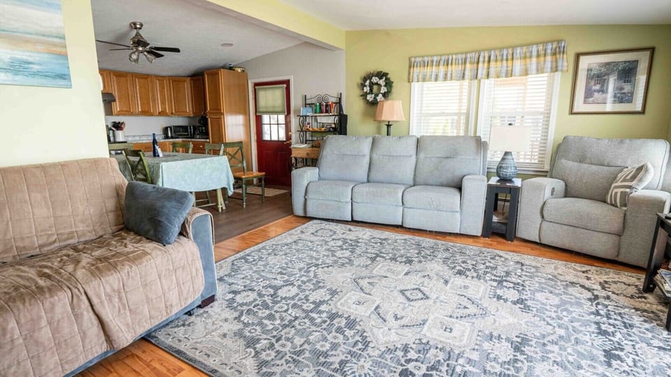 The open concept layout leads into a comfortable living room area with multiple windows and a patio door with lake views