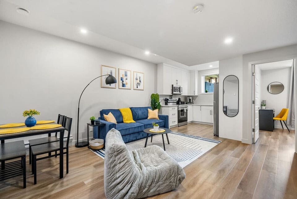 Living room with a double pull-out couch, dining area, electric fireplace & 50` Smart TV.