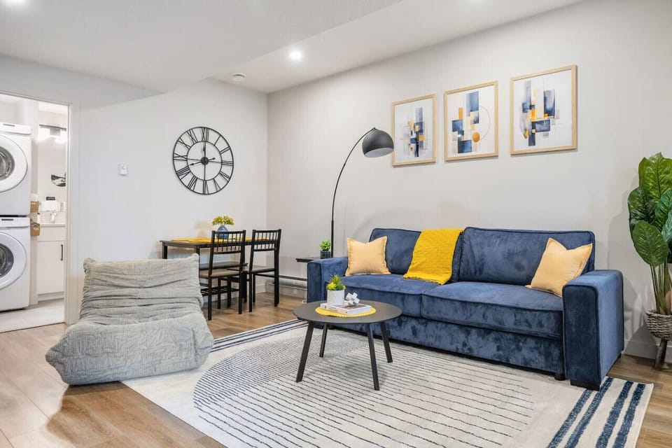 Living room with a double pull-out couch, dining area, electric fireplace & 50` Smart TV.