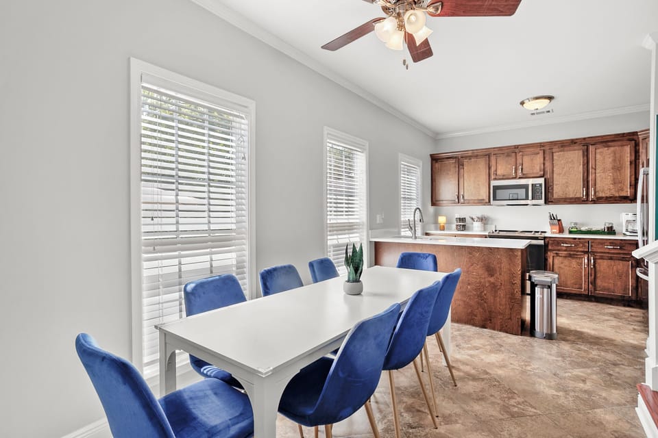 Dining Room: Gather around the chic white table with vibrant blue chairs for delightful meals!
