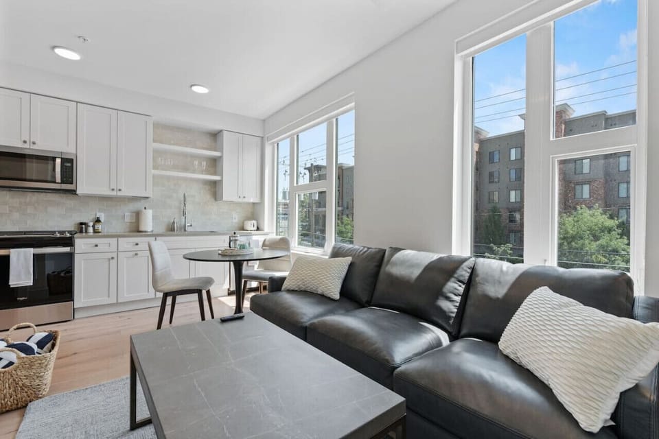 Beautifully designed living room. 65` TV, leather sofa and amazing views of mountains and city skyline.