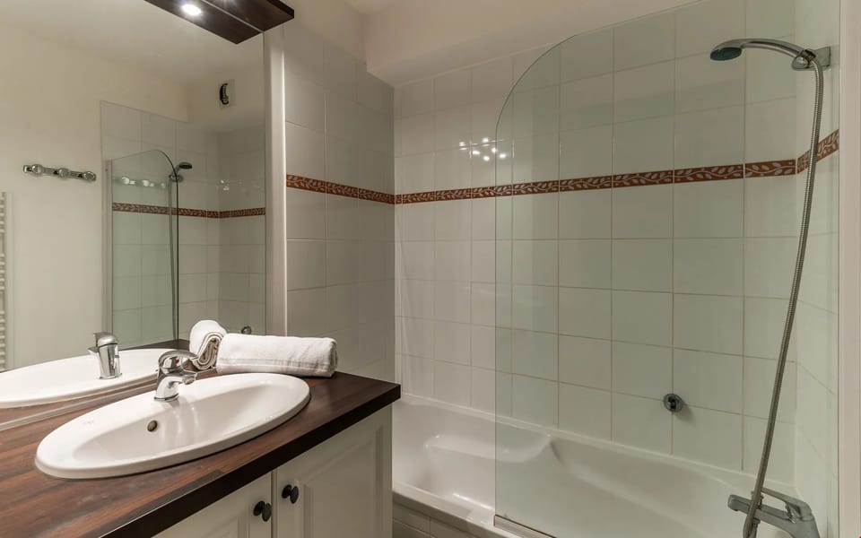 Get ready for the day in the modern and bright bathroom.