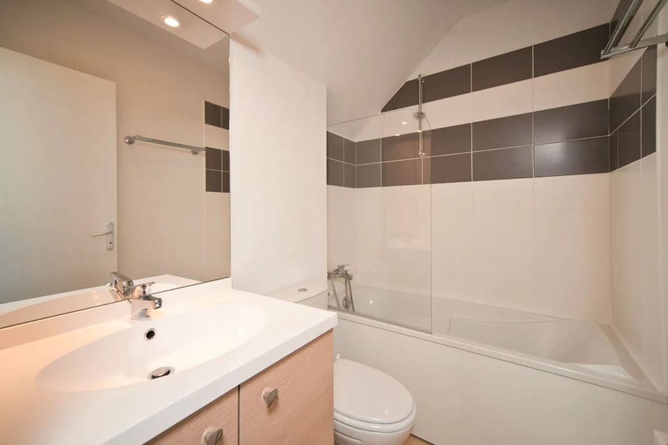 The spacious and modern bathroom features stylish décor.