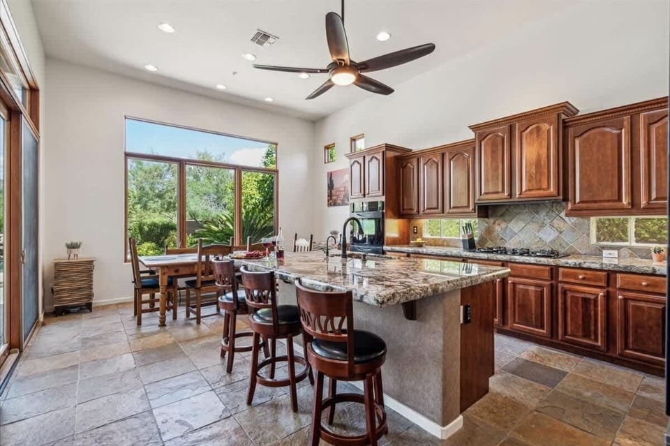 Stunning and fully equipped kitchen with speckled granite countertops and modern appliances.